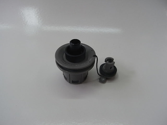 a black fire hydrant sitting in front of a wall