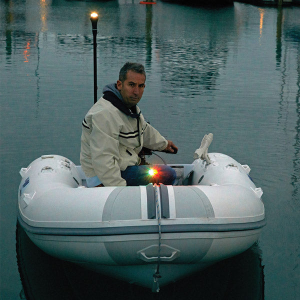 a man sitting on a boat in the water 